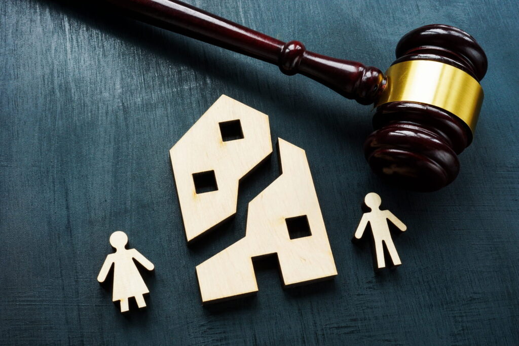 Divided wooden house with gavel and figures